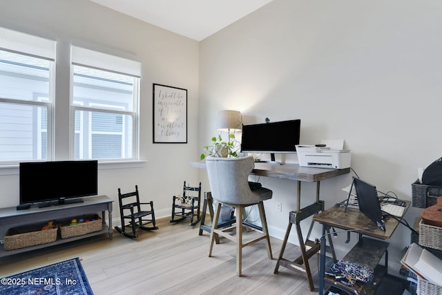 office space featuring baseboards and wood finished floors