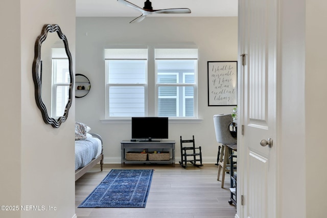 bedroom with baseboards and wood finished floors