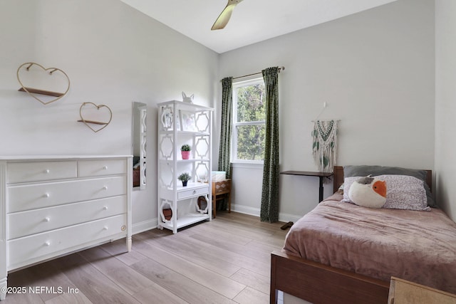 bedroom with wood finished floors, ceiling fan, and baseboards