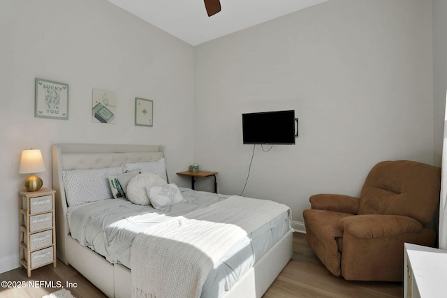 bedroom featuring wood finished floors, a ceiling fan, and baseboards
