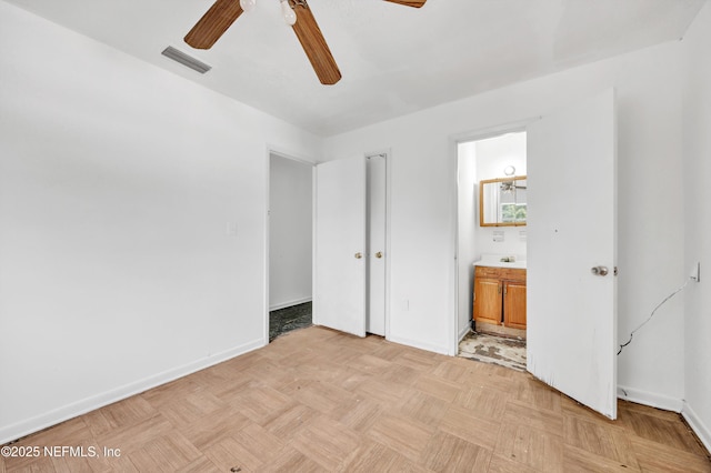 unfurnished bedroom with visible vents, ensuite bathroom, a ceiling fan, and baseboards
