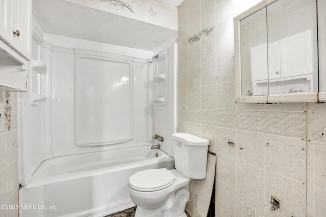 full bathroom featuring tile walls, toilet, and shower / bathtub combination