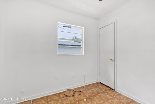 empty room featuring baseboards