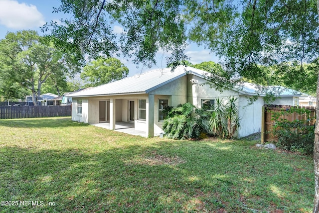 5329 Ogilvie Ln, Saint Augustine, FL 32086 - rear view of property featuring a yard, fence, a patio area, and stucco siding