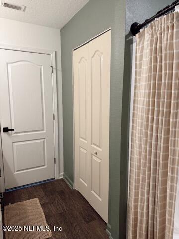 interior space featuring visible vents, wood finished floors, and curtained shower
