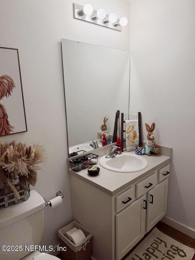 bathroom featuring vanity and toilet