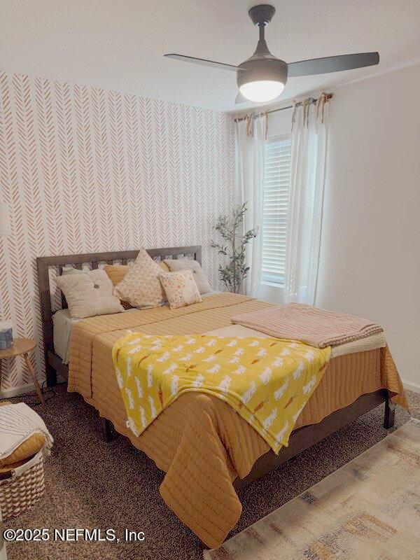 bedroom with carpet, a ceiling fan, wallpapered walls, and baseboards
