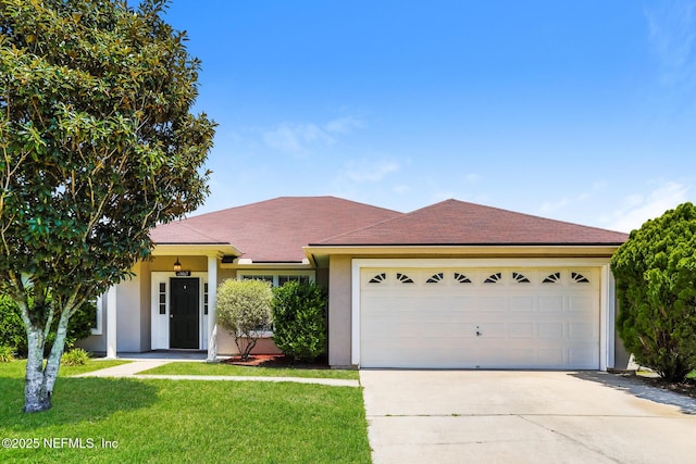 ranch-style house featuring a garage, stucco siding, driveway, and a front yard