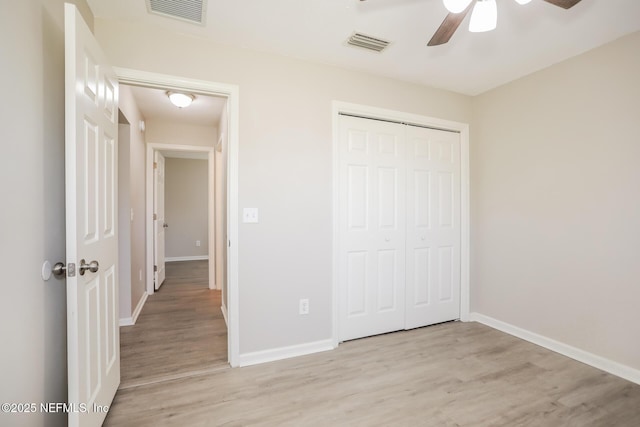 unfurnished bedroom featuring visible vents, light wood-type flooring, and baseboards