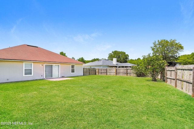 view of yard with a fenced backyard
