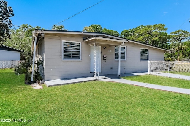 bungalow-style home with fence and a front yard