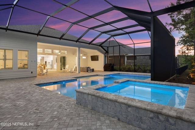 view of pool with a patio, a pool with connected hot tub, and ceiling fan