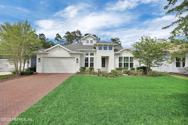 view of front of house with a shingled roof, an attached garage, a front lawn, and decorative driveway