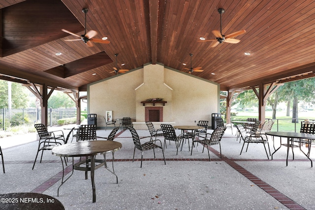 view of patio featuring a ceiling fan, fence, and outdoor dining space