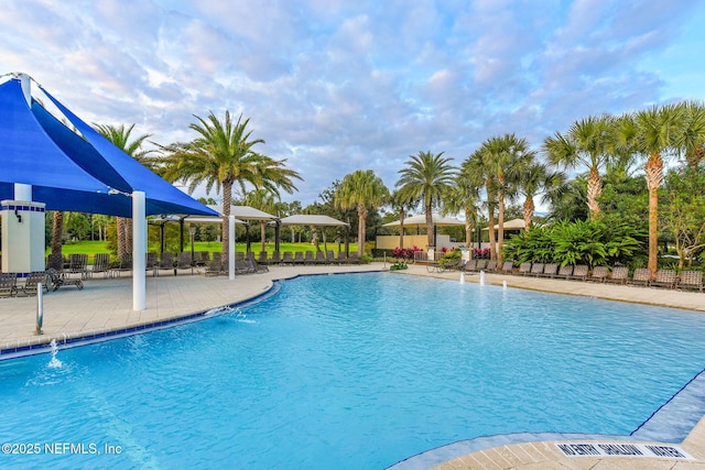 community pool featuring a patio and fence