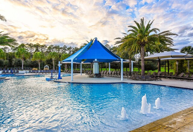 pool with fence, a gazebo, and a patio area
