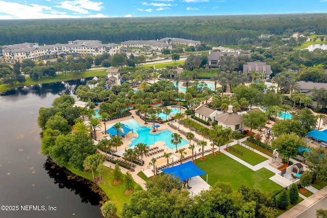 aerial view featuring a forest view and a water view