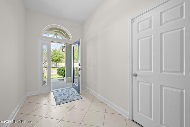entryway with light tile patterned floors and baseboards