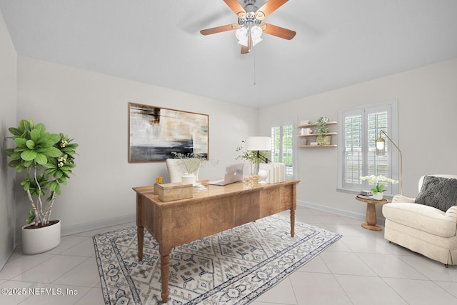 office space with light tile patterned floors, baseboards, and ceiling fan