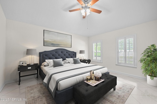bedroom featuring light tile patterned floors, baseboards, and a ceiling fan