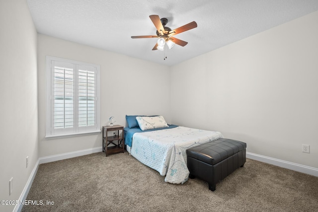 bedroom with carpet floors, a textured ceiling, baseboards, and ceiling fan