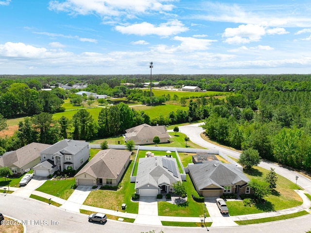 bird's eye view featuring a residential view and a forest view