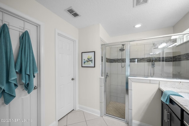 bathroom featuring visible vents, a shower stall, and tile patterned flooring