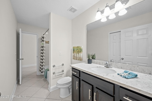 bathroom featuring visible vents, tile patterned flooring, vanity, toilet, and baseboards