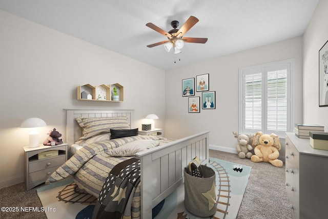 carpeted bedroom with baseboards and a ceiling fan