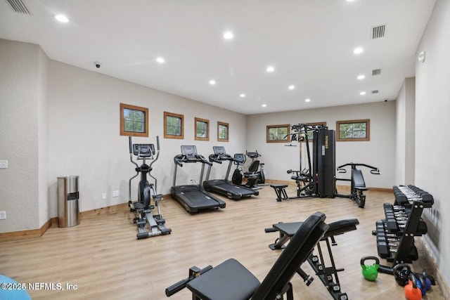 exercise room with recessed lighting, baseboards, visible vents, and wood finished floors