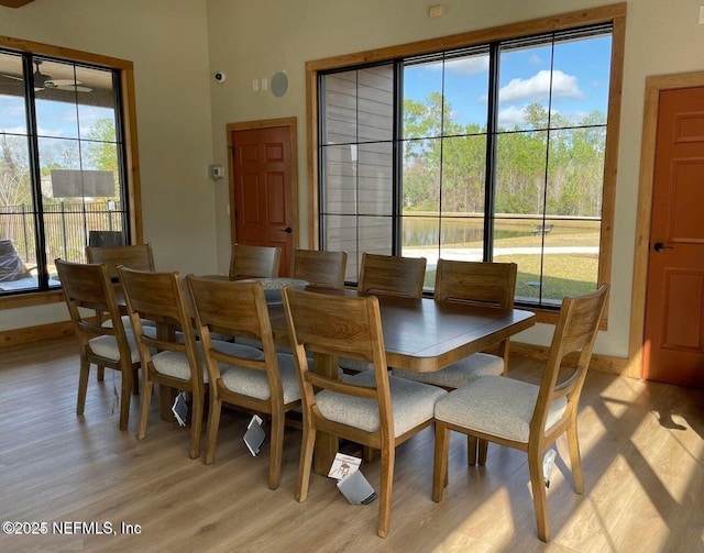 dining area with light wood-style floors and baseboards