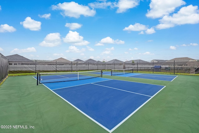 view of sport court with fence, community basketball court, and a residential view