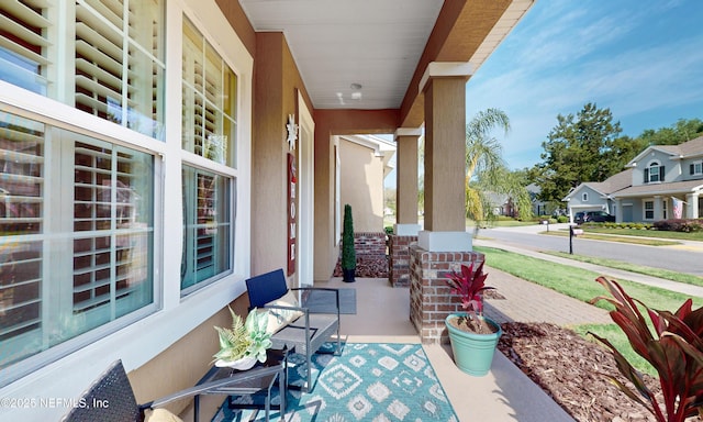 view of patio featuring covered porch and a residential view