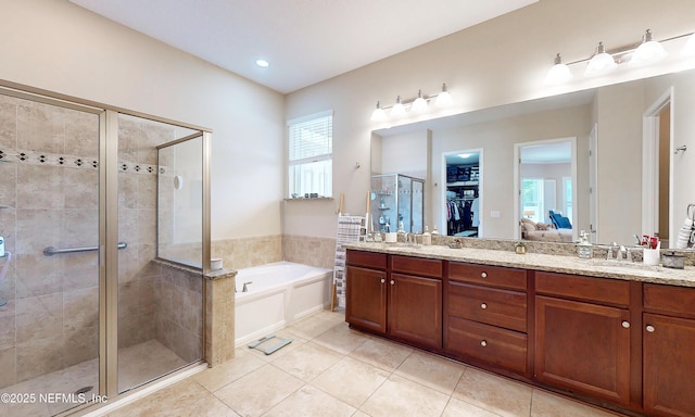 bathroom featuring a garden tub, double vanity, tile patterned flooring, and a shower stall