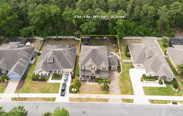 birds eye view of property with a residential view