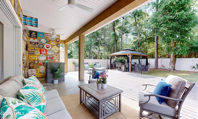 view of patio / terrace with ceiling fan, an outdoor living space, a gazebo, a fenced backyard, and outdoor dining space