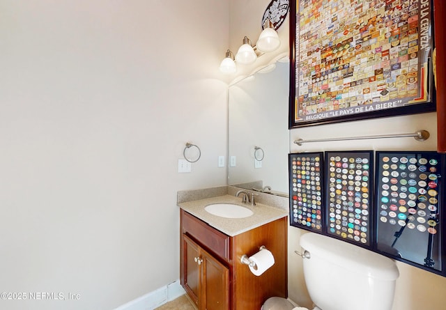 half bathroom featuring vanity and toilet