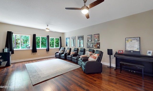 living room with baseboards, ceiling fan, and wood finished floors