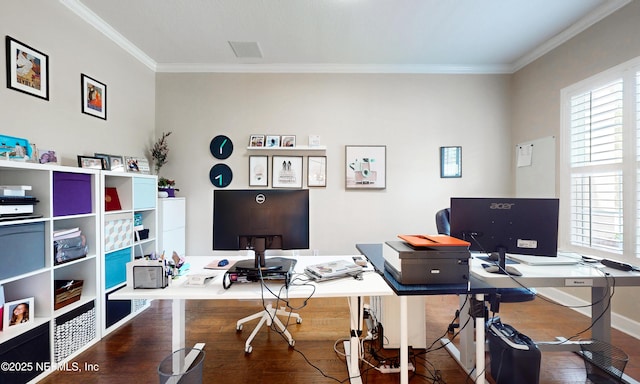 office with baseboards, visible vents, ornamental molding, and wood finished floors