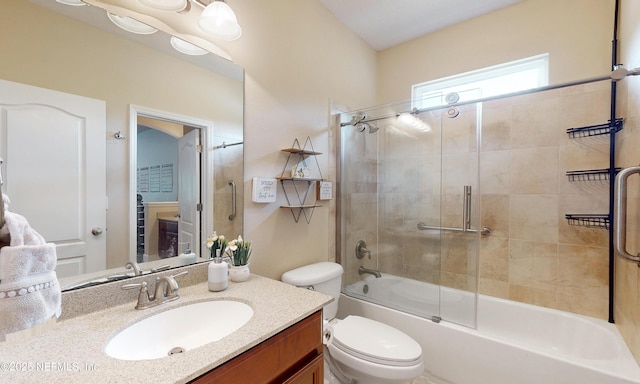 full bath with toilet, enclosed tub / shower combo, and vanity