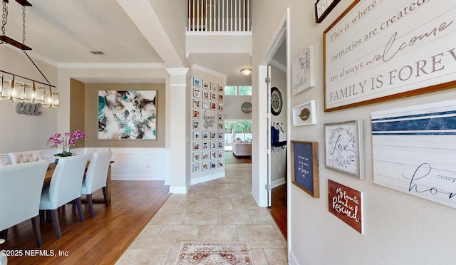 interior space with a chandelier, built in features, baseboards, visible vents, and ornamental molding