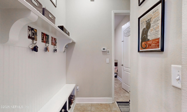 mudroom featuring baseboards and light tile patterned floors