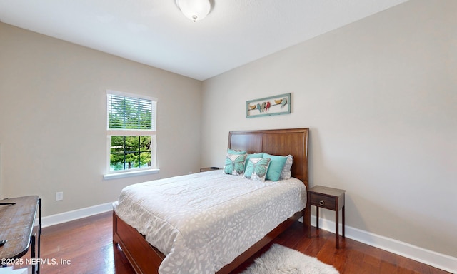 bedroom featuring dark wood-style flooring and baseboards
