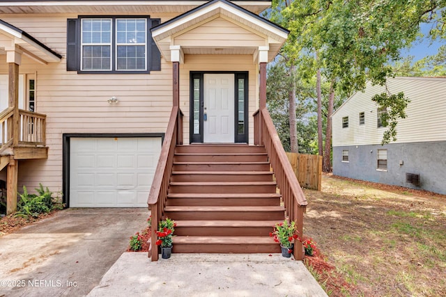 view of front of house featuring fence, an attached garage, and driveway
