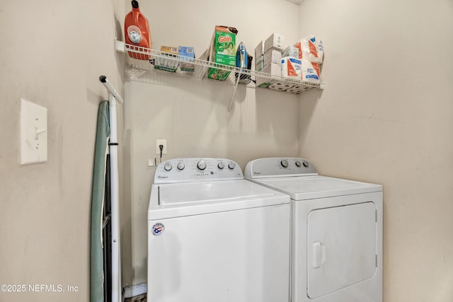 clothes washing area featuring laundry area and washer and clothes dryer