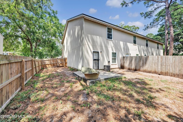 rear view of property with a fenced backyard