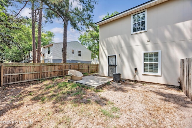 back of house with central air condition unit, a patio, and a fenced backyard