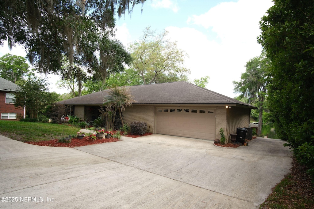 917 Arthur Moore Dr, Green Cove Springs, FL 32043 - single story home with concrete driveway, an attached garage, and brick siding