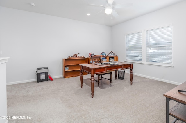 home office featuring carpet floors, a ceiling fan, and baseboards