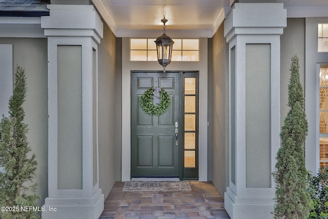 view of exterior entry with stucco siding